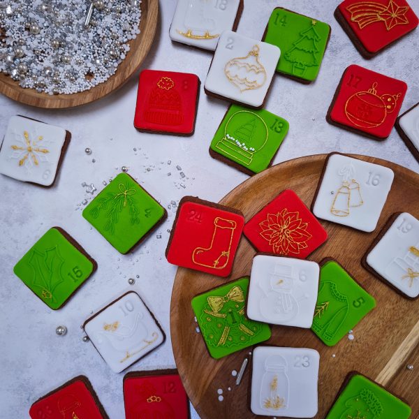 Mini square cookies in red, green and white with 24 different festive designs. Silver and white sprinkles