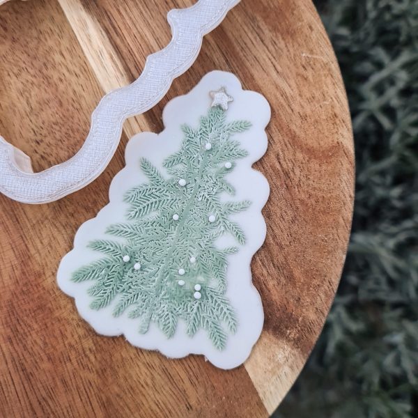 Christmas tree cookie on a wooden plate