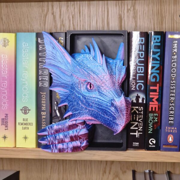 Blue and purple dragon book nook with a detailed dragon head emerging from a bookshelf, fantasy bookshelf decor for book lovers.